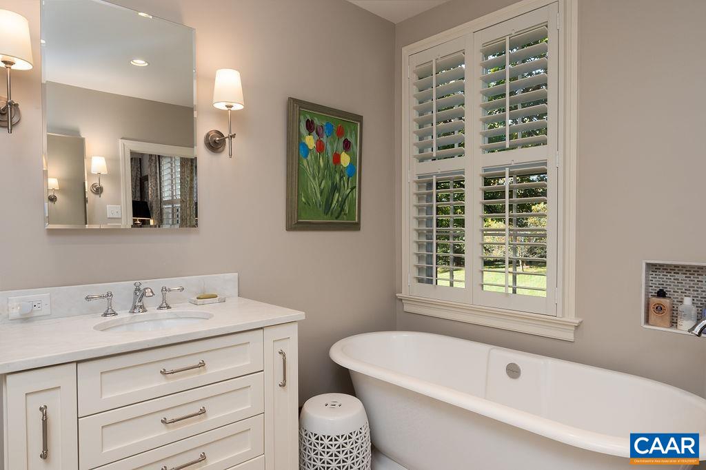 35 Old Farm Road Charlottesville, VA 22903 - Photo 29 of 44 a bathroom with a tub a sink and a large mirror