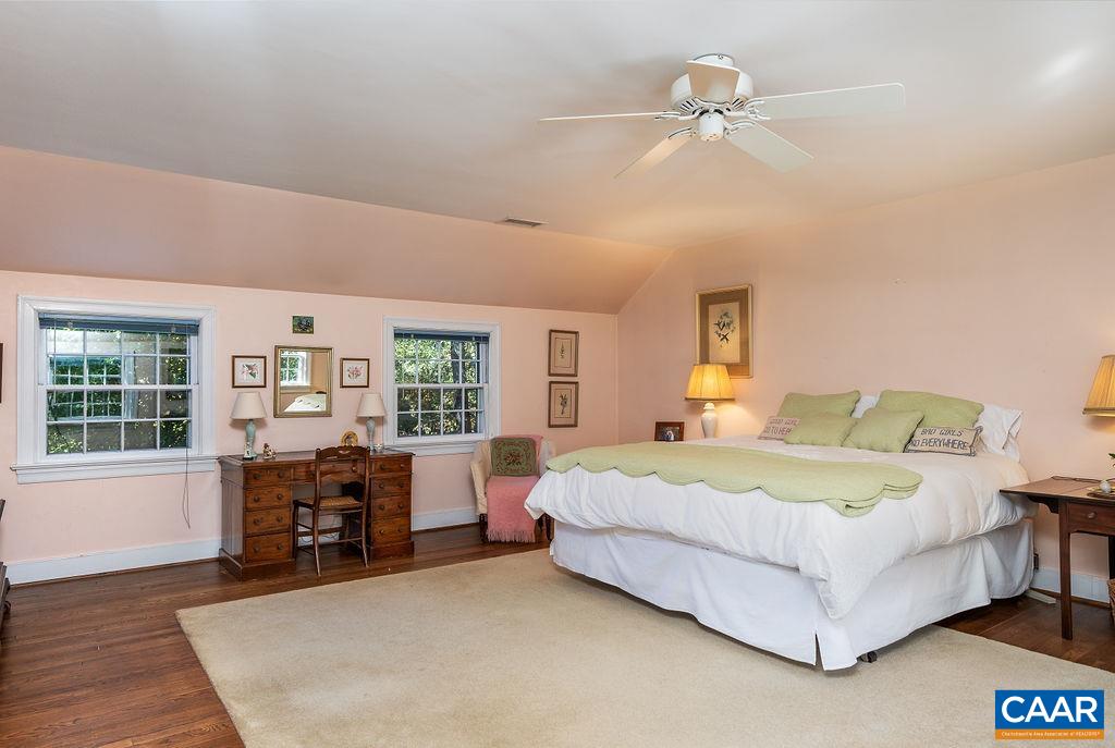35 Old Farm Road Charlottesville, VA 22903 - Photo 34 of 44 a bedroom with a large bed and wooden floor