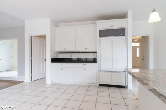 an empty room with a ceiling fan and windows