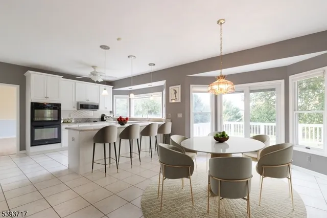 a living room with furniture a flat screen tv and a large window