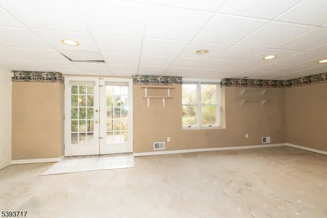 a view of an empty room with windows