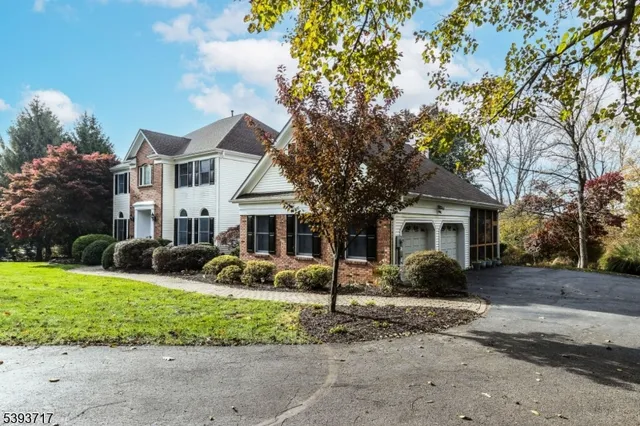a view of a livingroom with a chandelier a ceiling fan and windows
