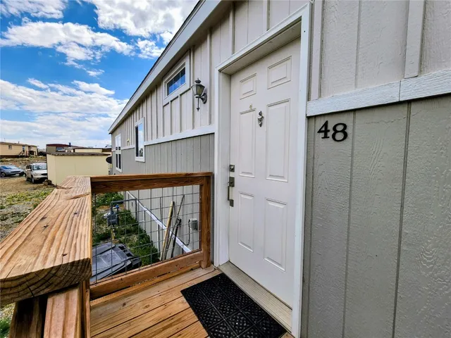 a view of a balcony with wooden floor and fence