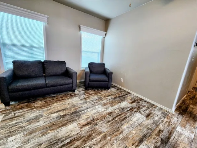 a kitchen with a sink a counter top space a refrigerator and a microwave