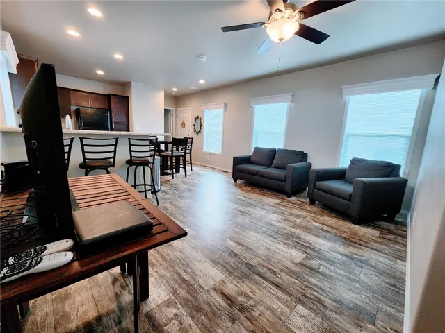 a living room with furniture and wooden floor