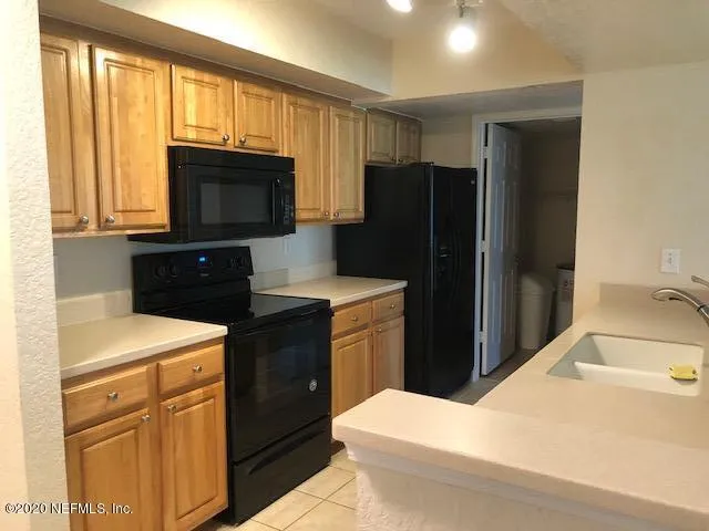 a kitchen with a refrigerator stove and sink
