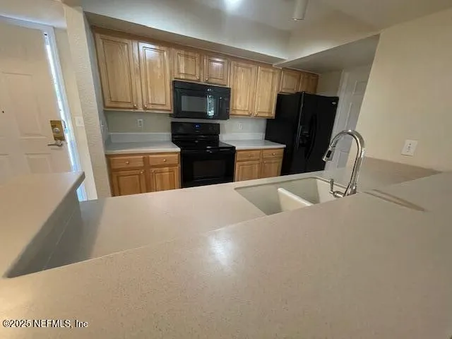 a kitchen with stainless steel appliances a refrigerator and a sink