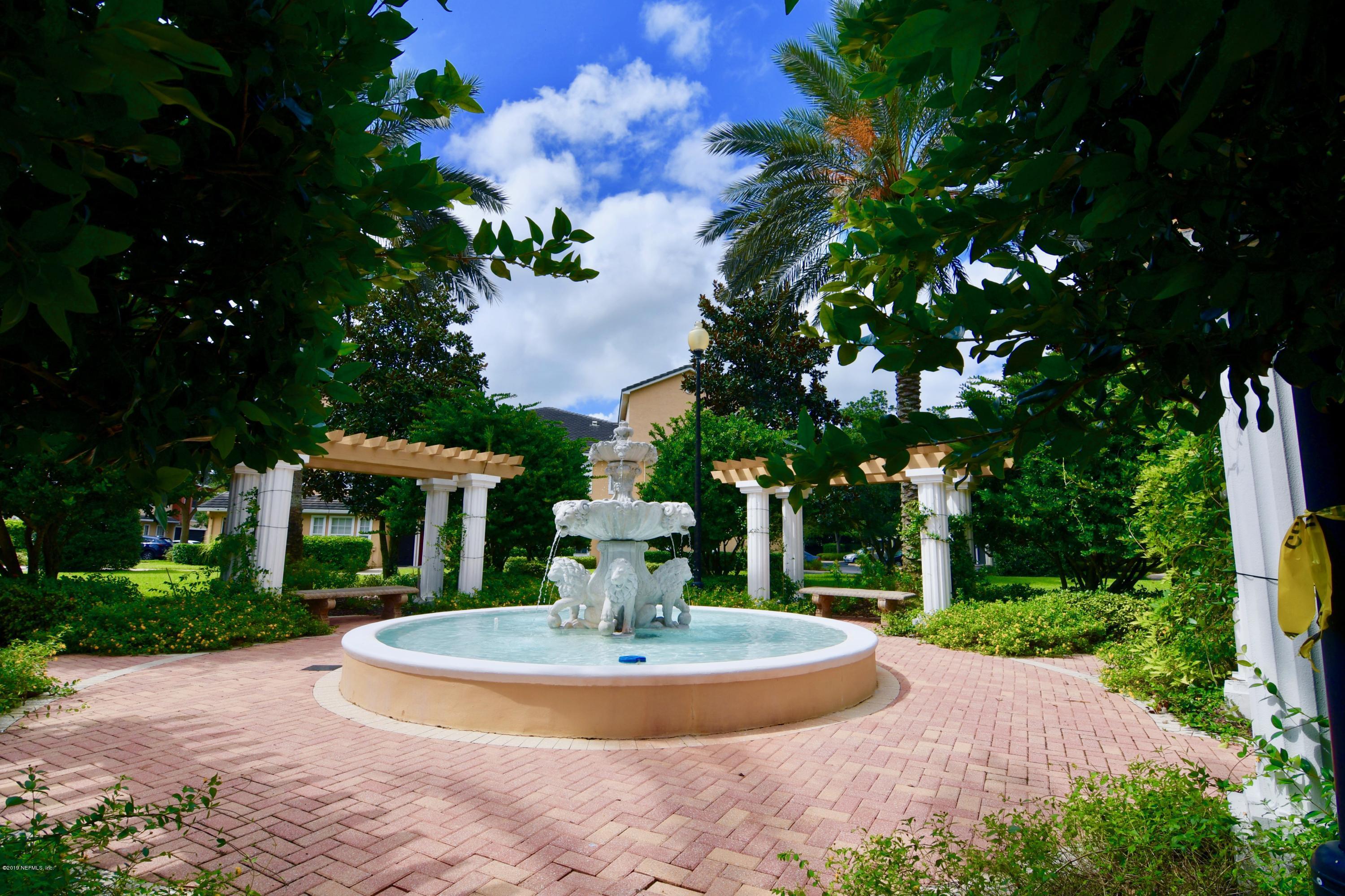 10075 Gate Parkway North, Unit 604 Jacksonville, FL 32246 - Photo 29 of 35 a view of a fountain in front of a house with large trees