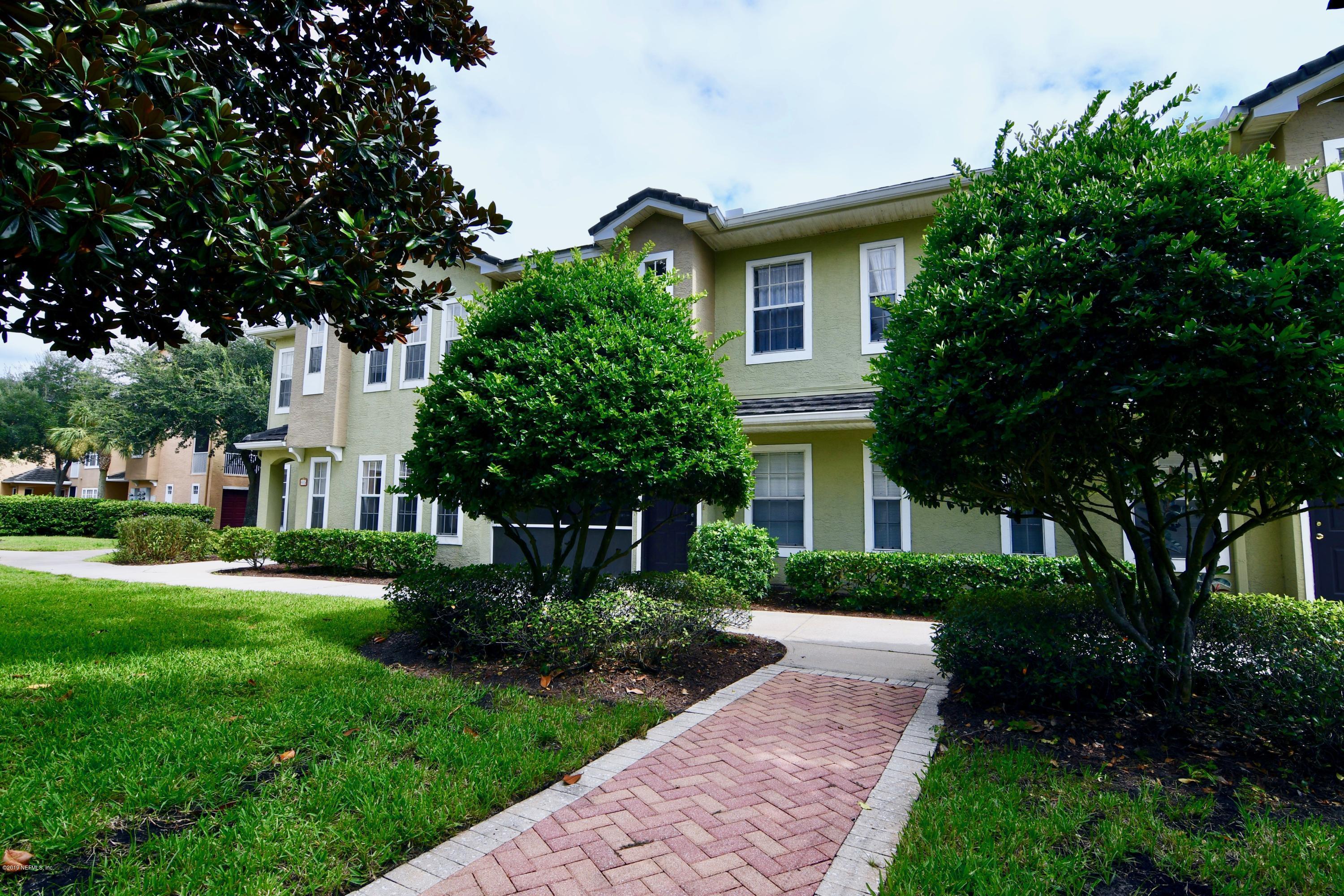10075 Gate Parkway North, Unit 604 Jacksonville, FL 32246 - Photo 30 of 35 a front view of a house with a yard and trees