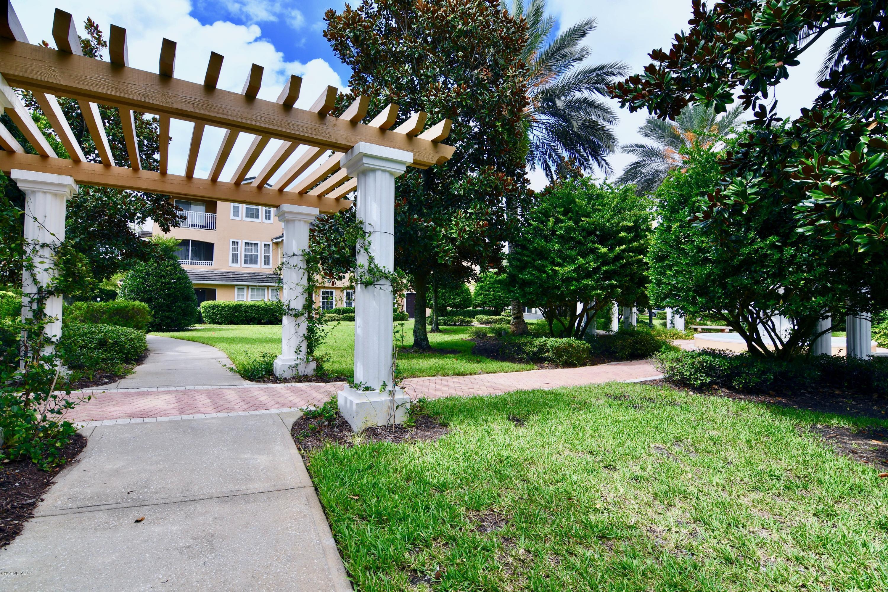 10075 Gate Parkway North, Unit 604 Jacksonville, FL 32246 - Photo 32 of 35 a view of a brick house with a yard and plants
