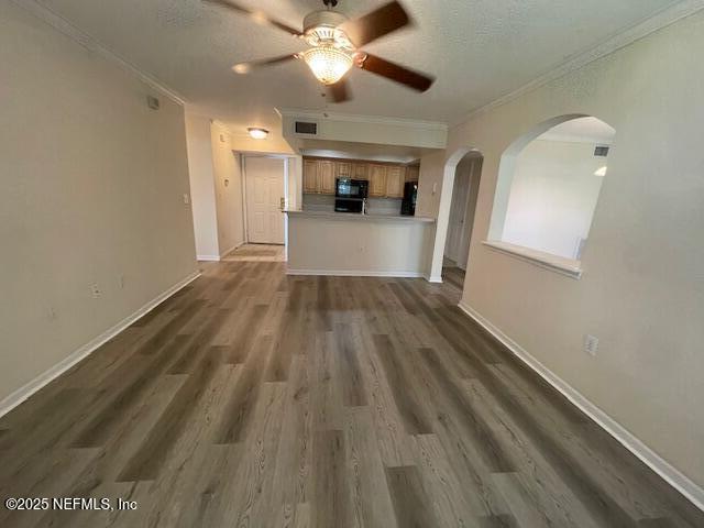 10075 Gate Parkway North, Unit 604 Jacksonville, FL 32246 - Photo 4 of 35 a view of a kitchen with wooden floor and a ceiling fan