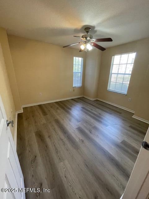 10075 Gate Parkway North, Unit 604 Jacksonville, FL 32246 - Photo 7 of 35 a view of an empty room with wooden floor and a window