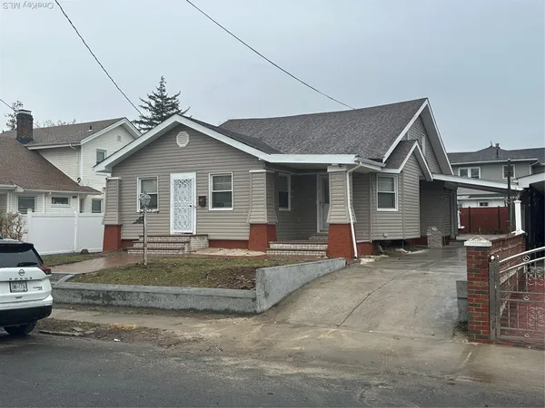 a view of a house with a patio and a yard