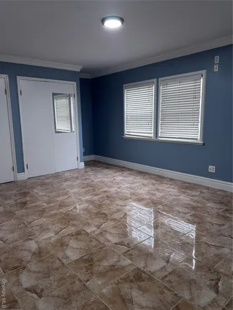 a view of an empty room with a window