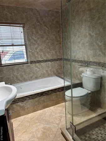a bathroom with a bathtub and a toilet