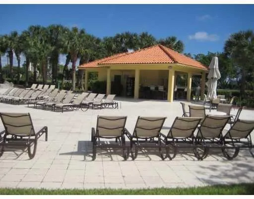 a view of a patio with table and chairs with wooden floor and fence
