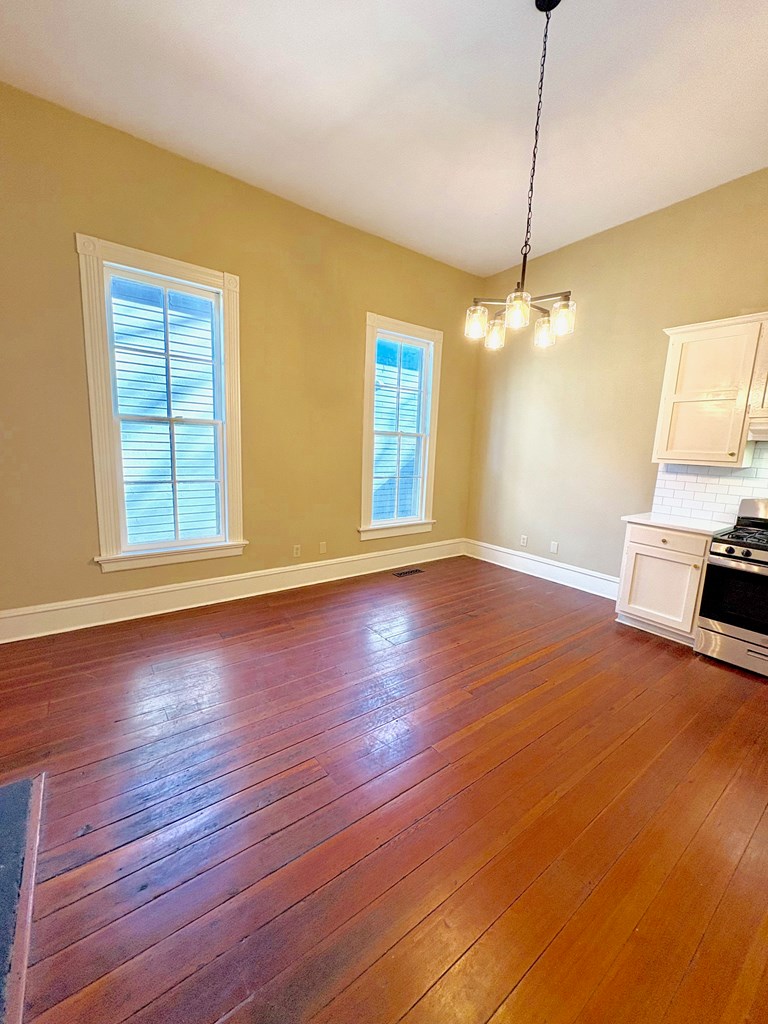 110 7th Street Columbus, GA 31901 - Photo 12 of 24 a view of livingroom with hardwood floor and ceiling fan