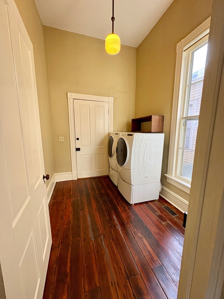 110 7th Street Columbus, GA 31901 - Photo 13 of 24 a view of an empty room with wooden floor and a window