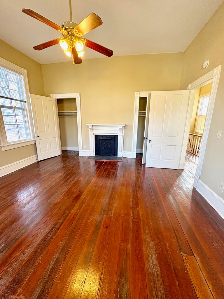 110 7th Street Columbus, GA 31901 - Photo 20 of 24 a view of empty room with wooden floor and fan