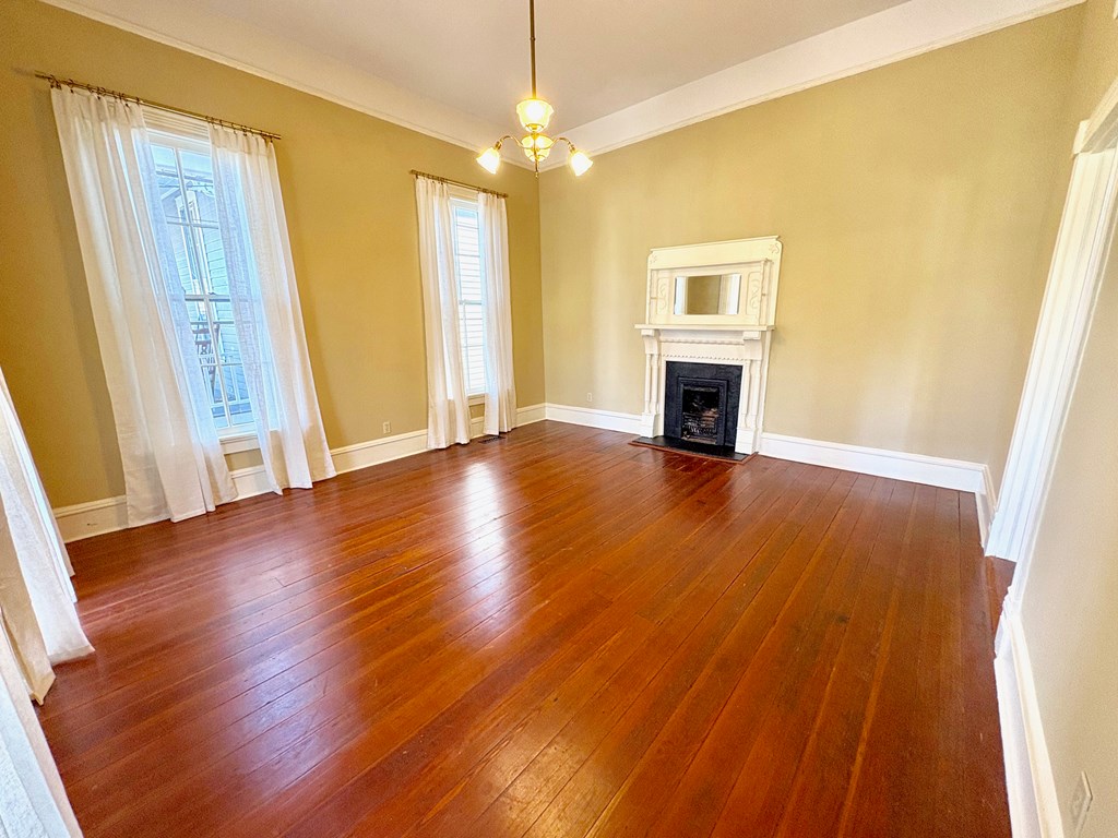 110 7th Street Columbus, GA 31901 - Photo 6 of 24 a view of a livingroom with wooden floor fireplace and window