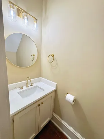a bathroom with a sink mirror and vanity