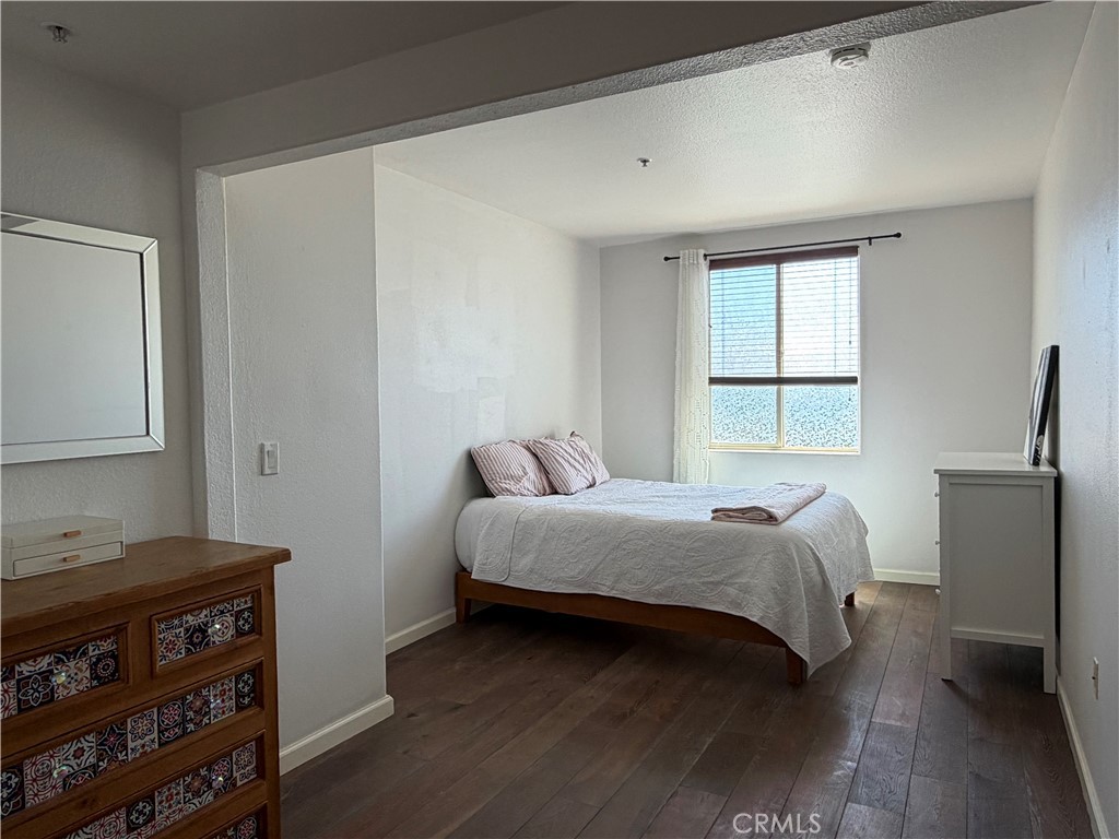 3740 Santa Rosalia Drive, Unit 425 Los Angeles, CA 90008 - Photo 12 of 24 a bedroom with a bed and a dresser