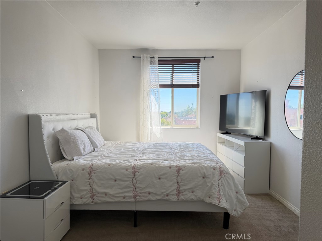 3740 Santa Rosalia Drive, Unit 425 Los Angeles, CA 90008 - Photo 13 of 24 a bedroom with a bed and a window