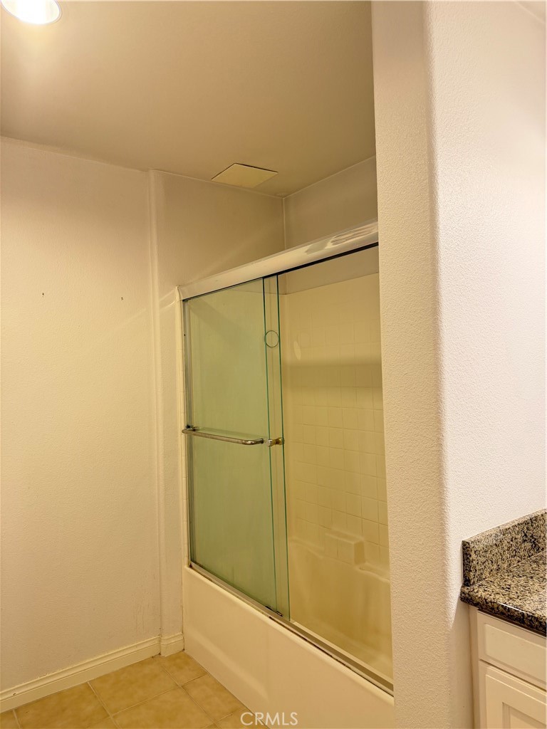 3740 Santa Rosalia Drive, Unit 425 Los Angeles, CA 90008 - Photo 17 of 24 a bathroom with a granite countertop shower and a sink