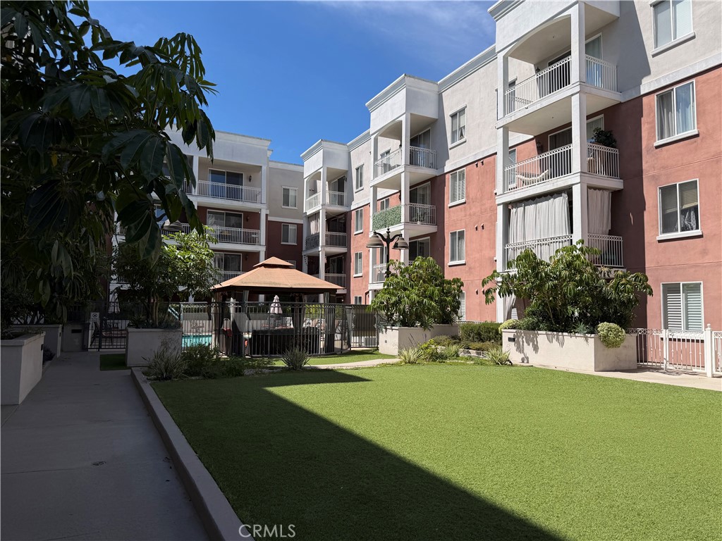 3740 Santa Rosalia Drive, Unit 425 Los Angeles, CA 90008 - Photo 18 of 24 a swimming pool with outdoor seating and yard