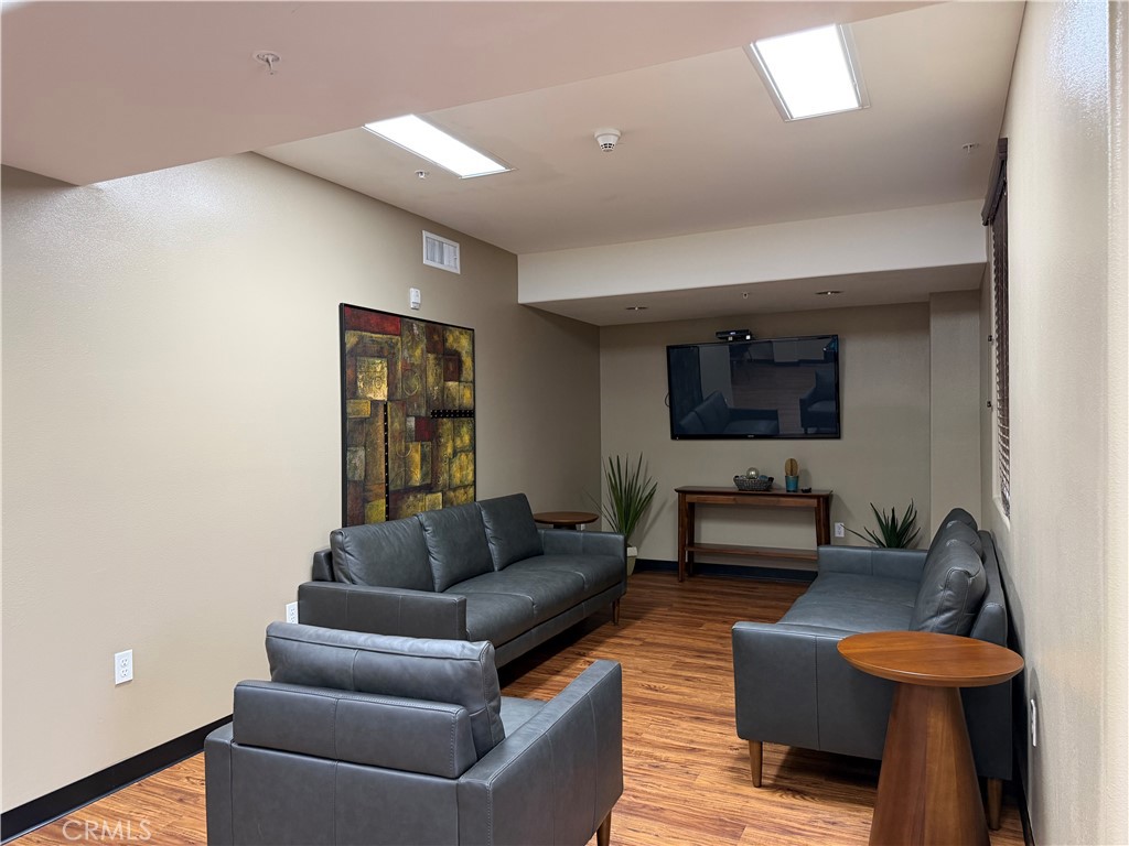 3740 Santa Rosalia Drive, Unit 425 Los Angeles, CA 90008 - Photo 22 of 24 a living room with furniture and a flat screen tv