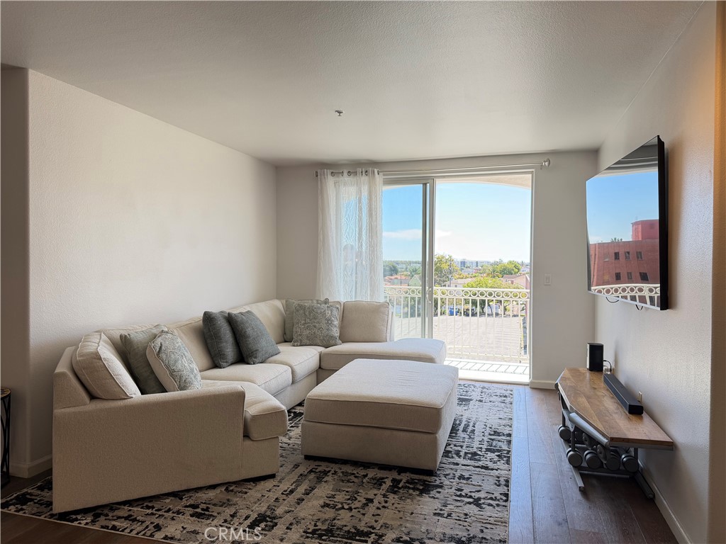 3740 Santa Rosalia Drive, Unit 425 Los Angeles, CA 90008 - Photo 5 of 24 a living room with furniture and a large window