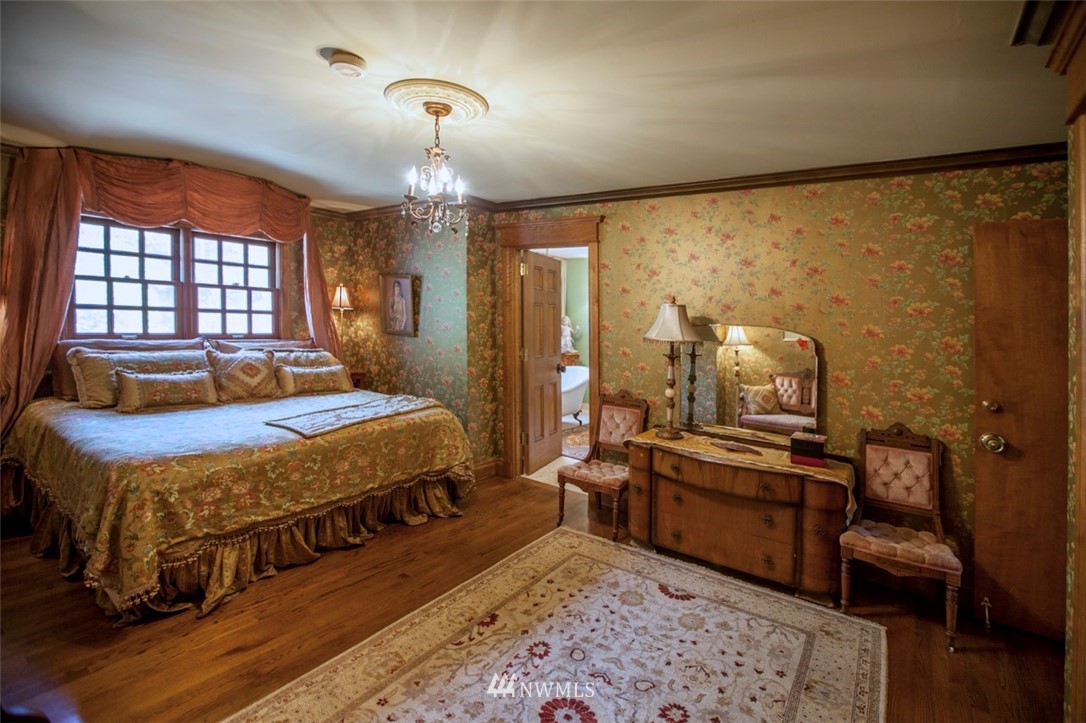 776 H Street Road Lynden, WA 98264 - Photo 18 of 25 a bedroom with a bed a chandelier and dresser