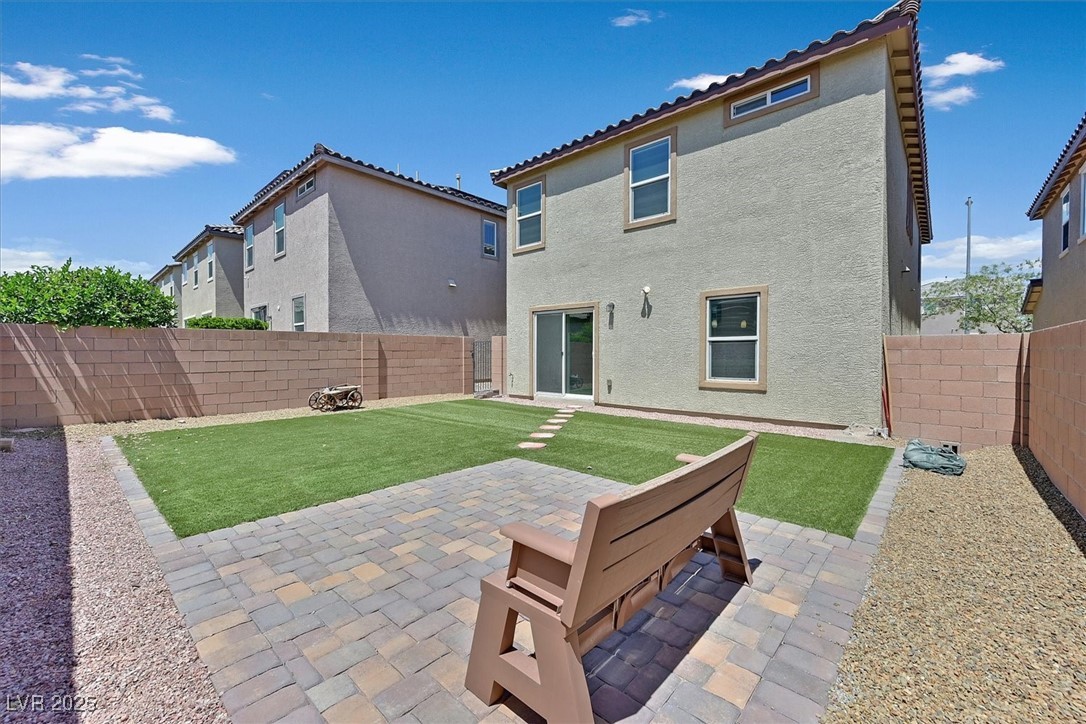 8755 Spanish Ridge Avenue Las Vegas, NV 89148 - Photo 15 of 16 Back of house with stucco siding, a patio, and a tile roof