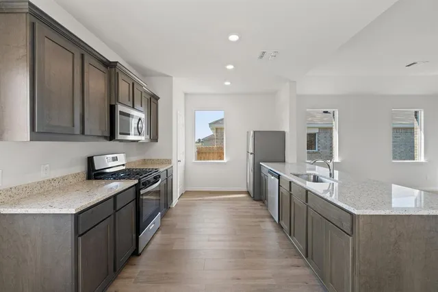 a large kitchen with stainless steel appliances granite countertop lots of counter top space