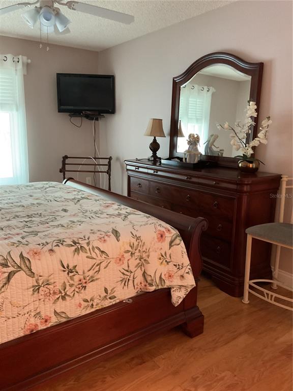 2655 Pine Ridge Way North, Unit D3 Palm Harbor, FL 34684 - Photo 22 of 31 a bedroom with a bed and a flat screen tv