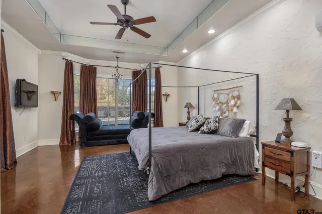 a bedroom with a bed and a television