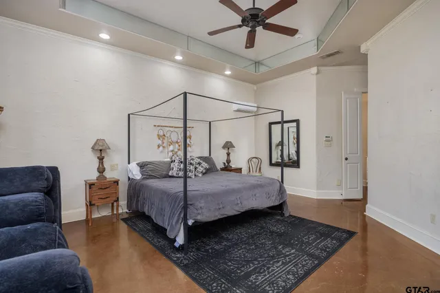 a bedroom with a large bed and a chandelier