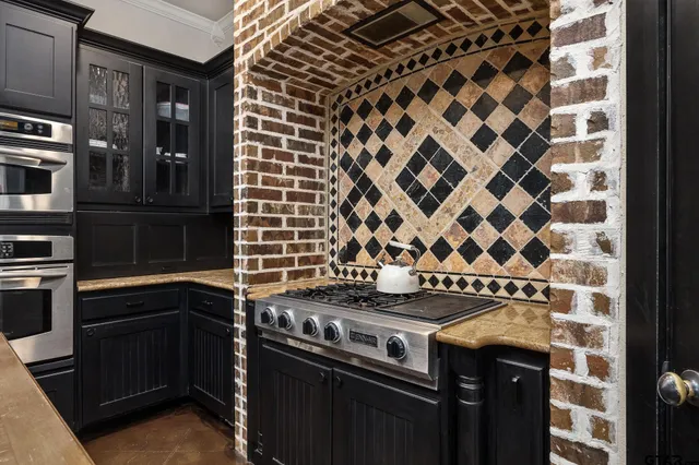a bathroom with a granite countertop sink a mirror and a bathtub