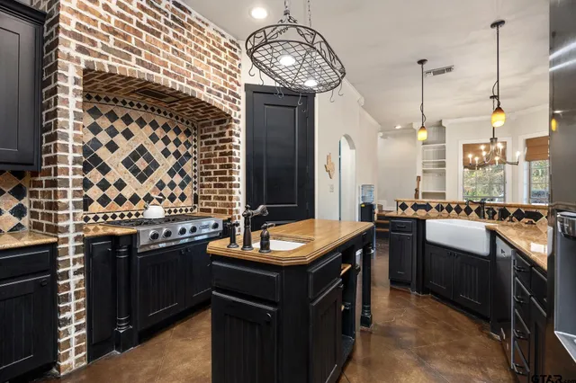 a bathroom with a granite countertop toilet sink and mirror