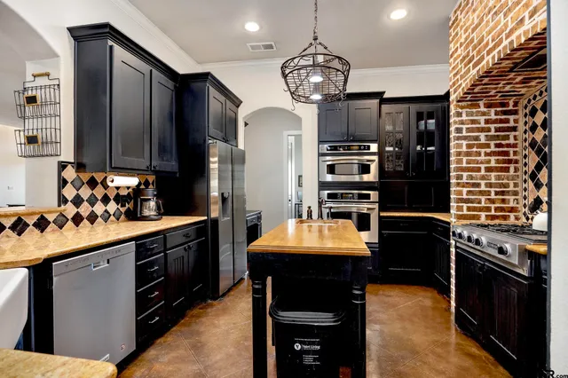 a bedroom with a bed a chandelier and closet