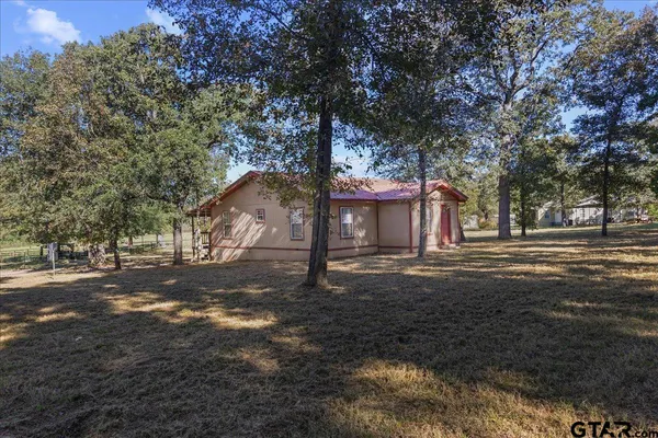 a view of a trees with a yard