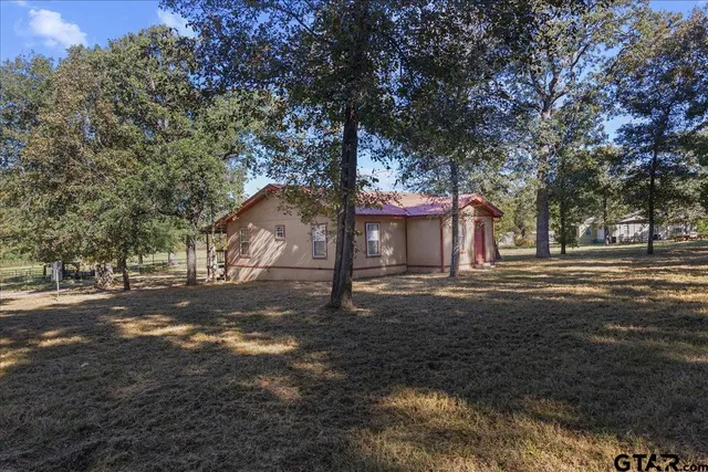 a view of a trees with a yard