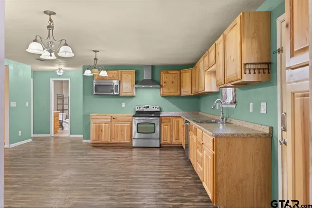 a kitchen with stainless steel appliances granite countertop a stove and cabinets