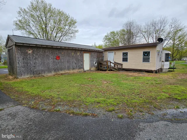 a view of a backyard with a small cabin