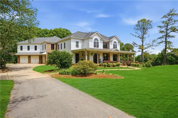 a front view of a house with garden