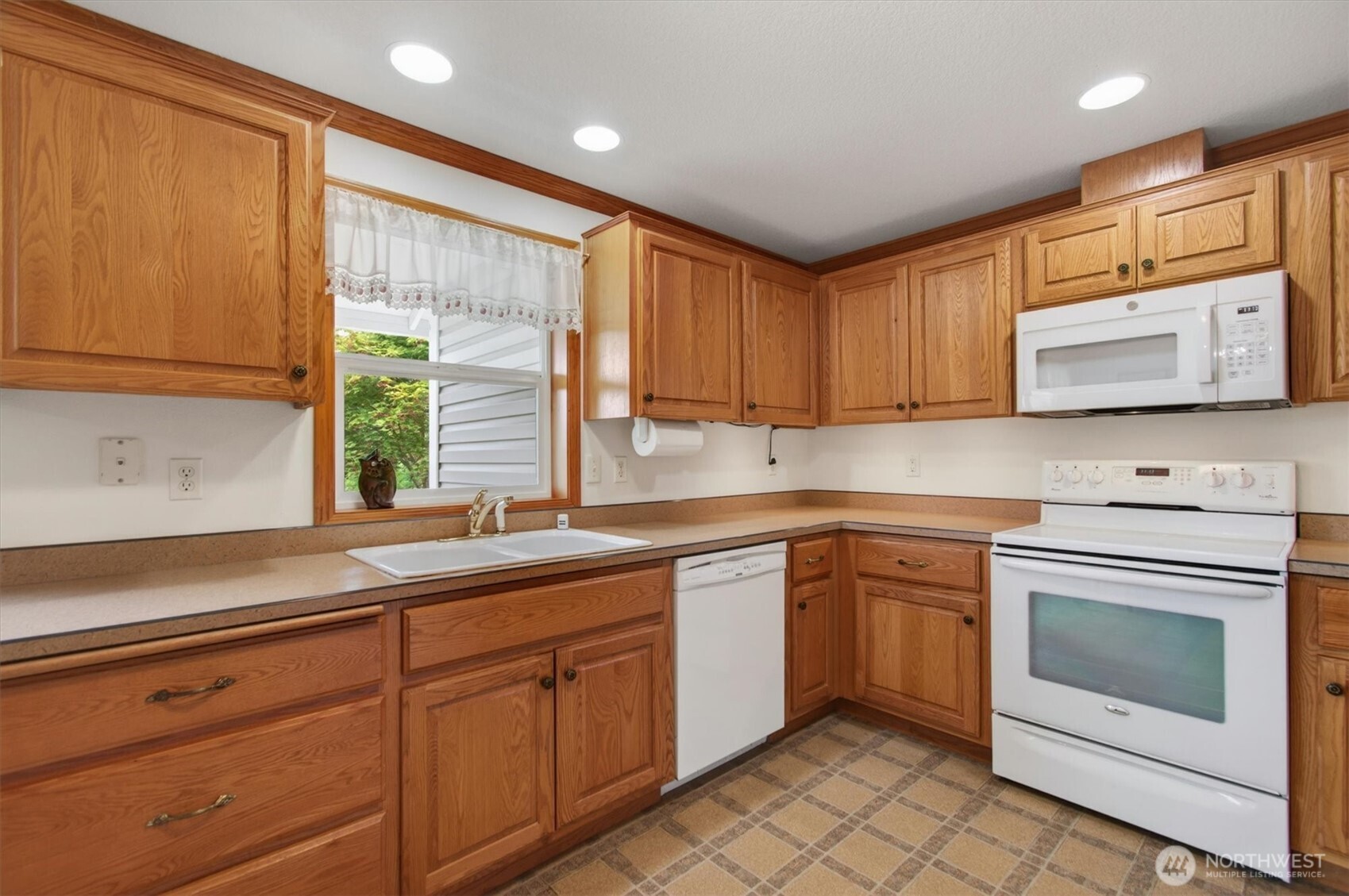 218 West Sunny Sands Road Cathlamet, WA 98612 - Photo 14 of 40 a kitchen with stainless steel appliances granite countertop white cabinets sink and window