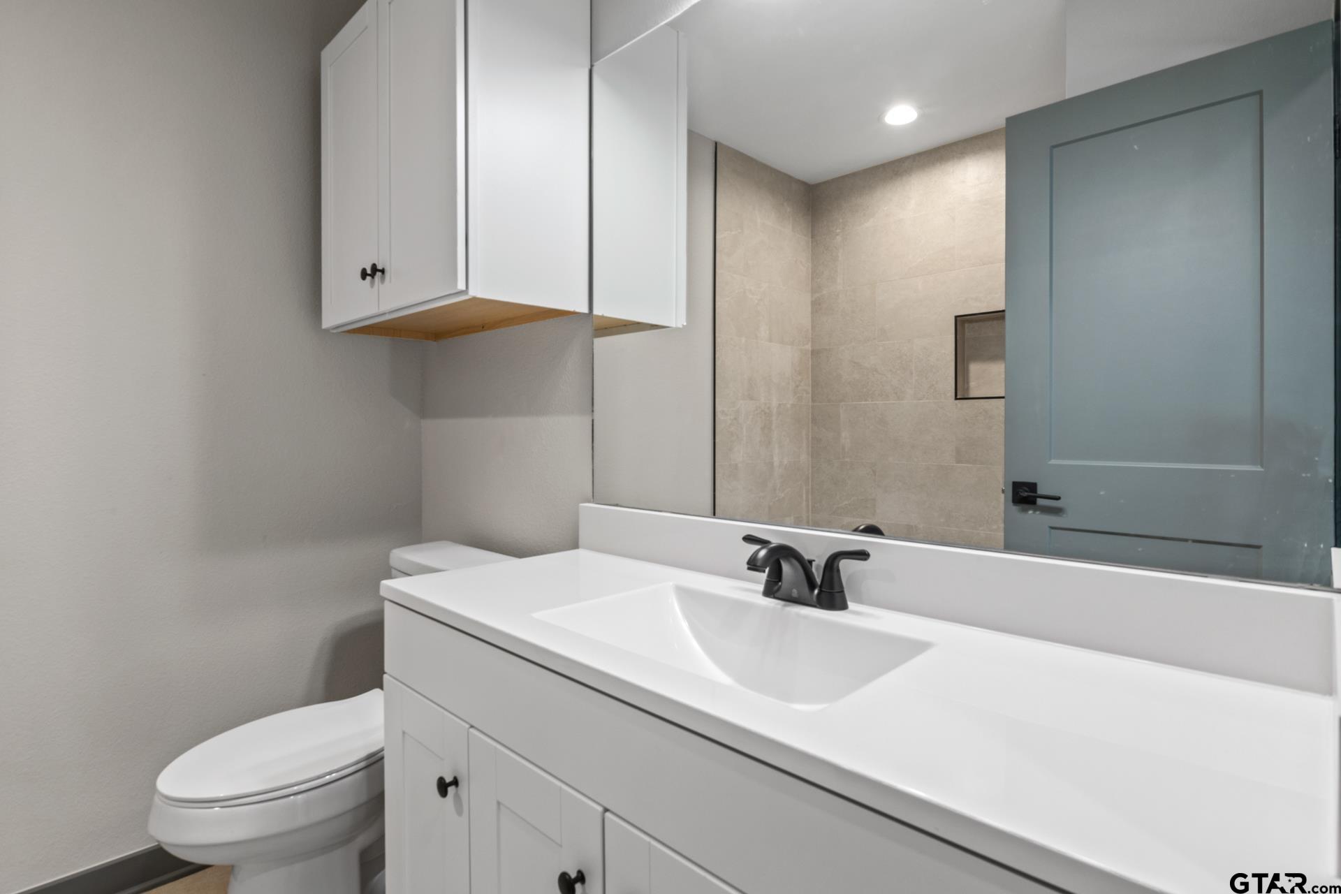 109 Yates Street Mount Vernon, TX 75457 - Photo 15 of 23 a bathroom with a sink toilet and vanity