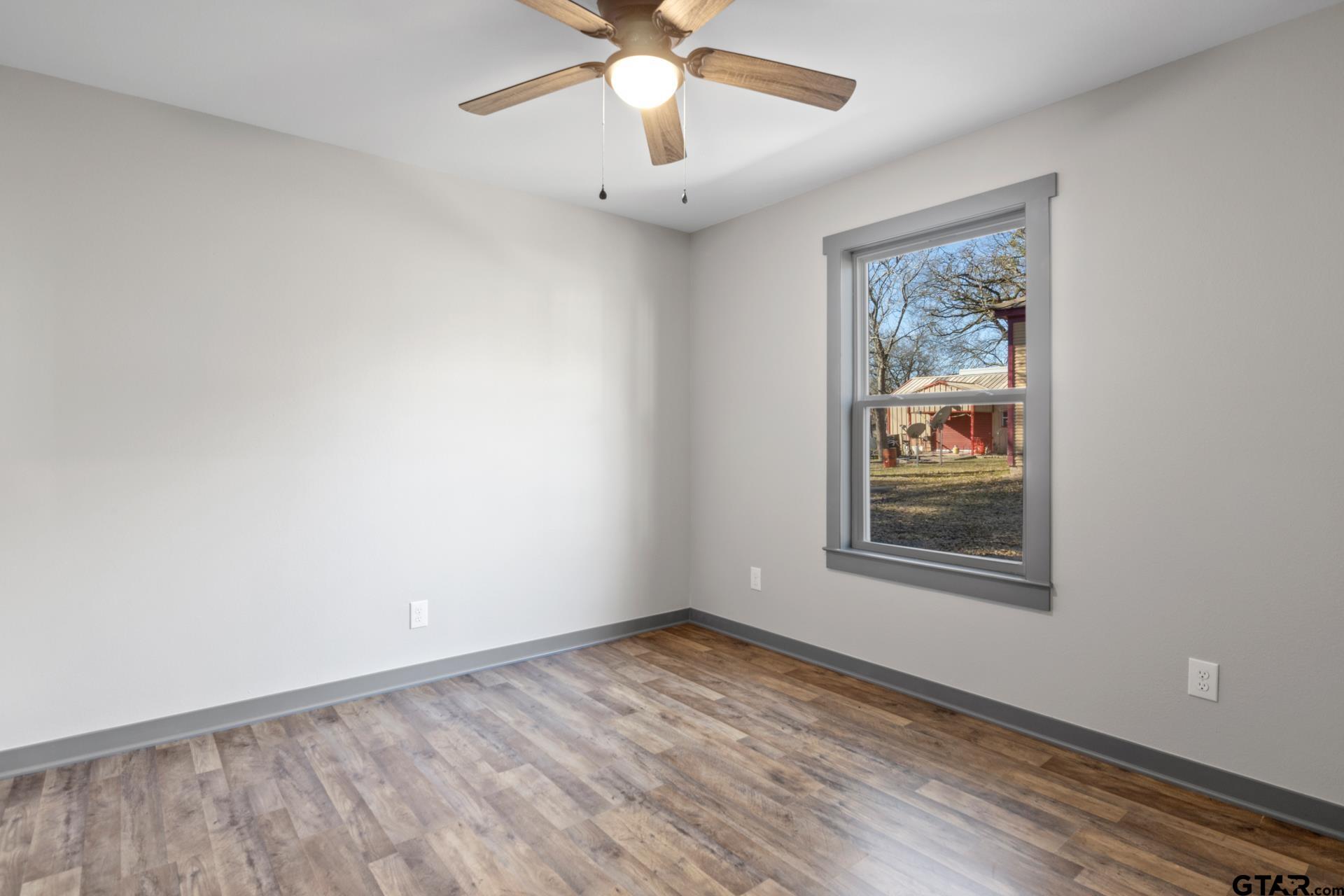 109 Yates Street Mount Vernon, TX 75457 - Photo 17 of 23 an empty room with a window and a fan