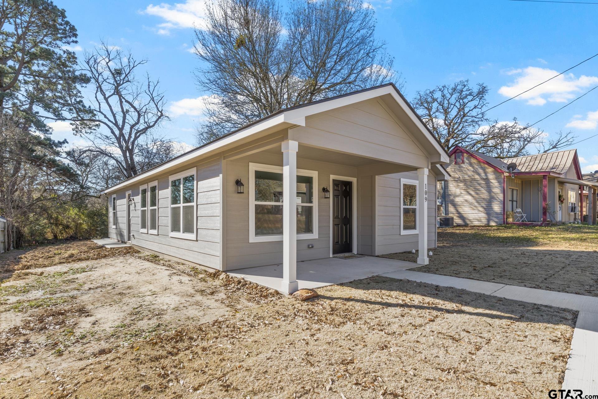109 Yates Street Mount Vernon, TX 75457 - Photo 2 of 23 a view of a house with a yard covered in snow