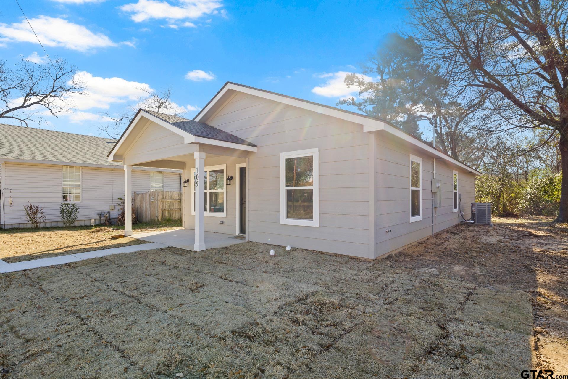 109 Yates Street Mount Vernon, TX 75457 - Photo 3 of 23 a view of a house with backyard and trees